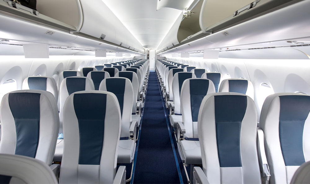 Aero-Commercial-1 Interior view of a passenger aircraft seats with blue and grey decor